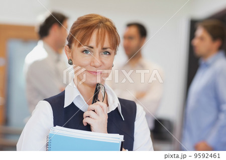 Lovely female mature student posing in classroom 9592461