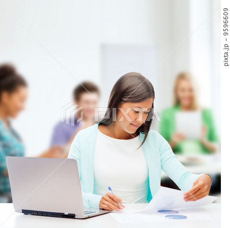 asian businesswoman with laptop and documents asian businesswoman with laptop and documents 9596609
