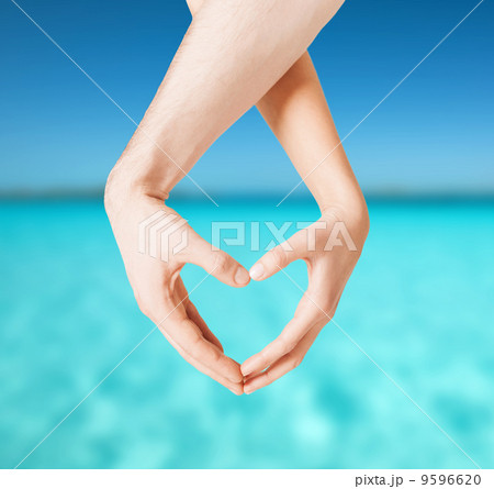 woman and man hands showing heart shape woman and man hands showing heart shape 9596620