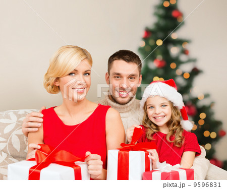 smiling family holding many gift boxes 9596831