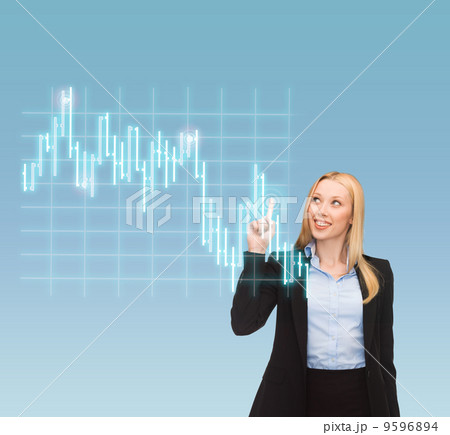smiling businesswoman pointing to forex chart 9596894