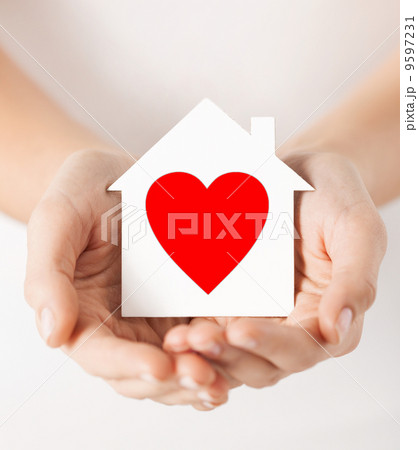 hands holding white paper house 9597231