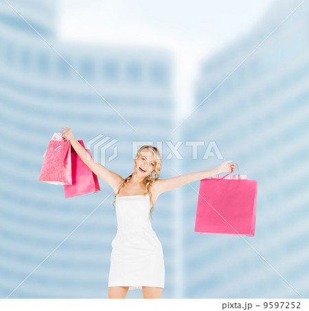woman with shopping bags in dress woman with shopping bags in dress 9597252