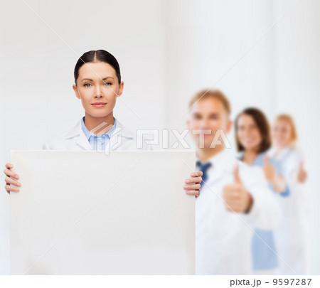 calm female doctor with white blank board calm female doctor with white blank board 9597287