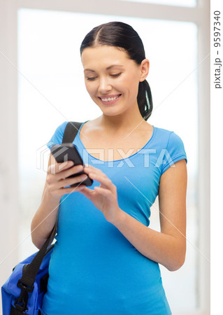 smiling female student with smartphone and bag smiling female student with smartphone and bag 9597340