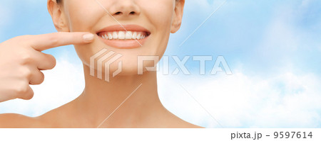 beautiful woman pointing to teeth 9597614
