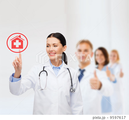 smiling female doctor pointing to something 9597617