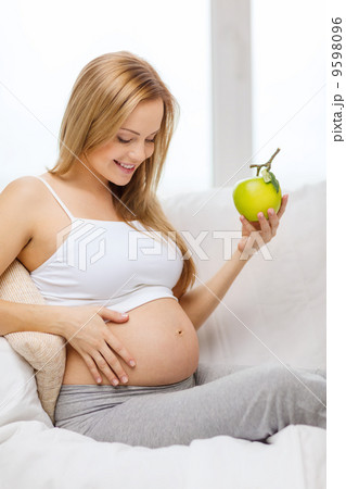 happy pregnant woman with fresh green apple happy pregnant woman with fresh green apple 9598096