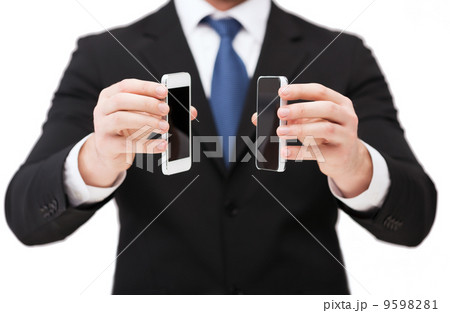 businessman showing smartphones with blank screens businessman showing smartphones with blank screens 9598281