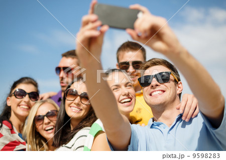 group of friends taking picture with smartphone 9598283
