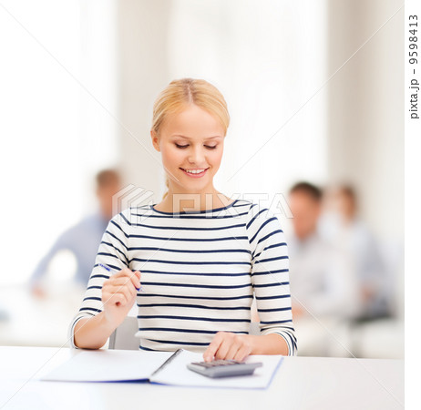 woman with notebook and calculator studying 9598413