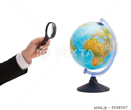 businessman hand holding magnifier over globe businessman hand holding magnifier over globe 9598507
