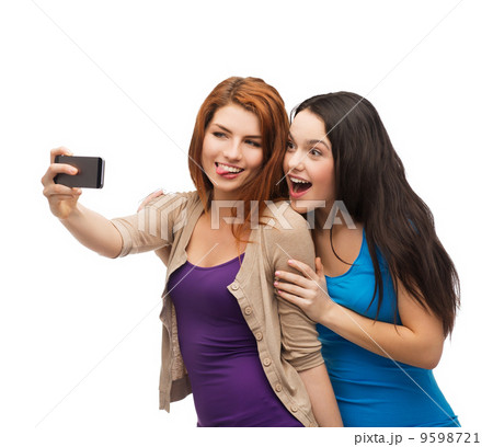 two smiling teenagers with smartphone two smiling teenagers with smartphone 9598721