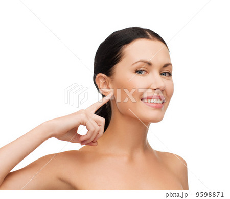 young calm woman pointing to her ear 9598871