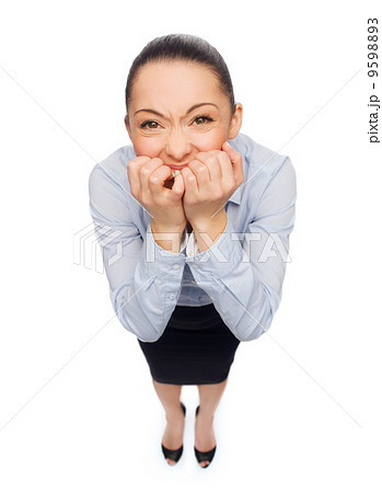 frightened businesswoman biting her fingers 9598893