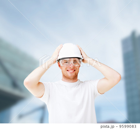 male architect in helmet with safety glasses 9599083