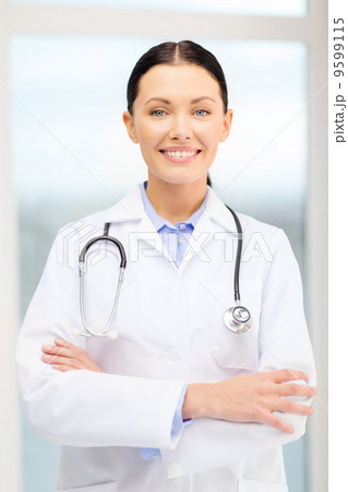 smiling young doctor with stethoscope in cabinet 9599115