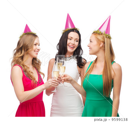 three women in pink hats with champagne glasses three women in pink hats with champagne glasses 9599138