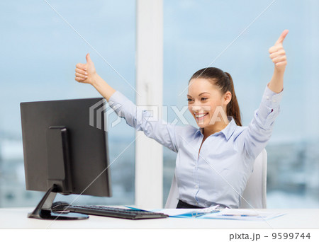 woman with computer, papers showing thumbs up woman with computer, papers showing thumbs up 9599744