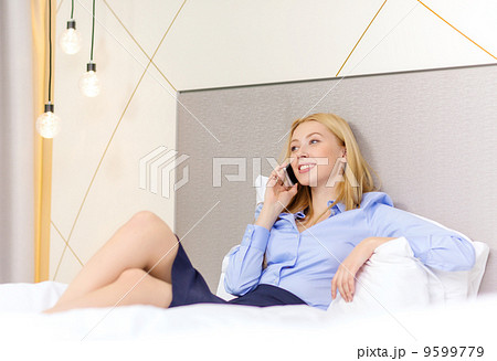happy businesswoman with smartphone in hotel room happy businesswoman with smartphone in hotel room 9599779