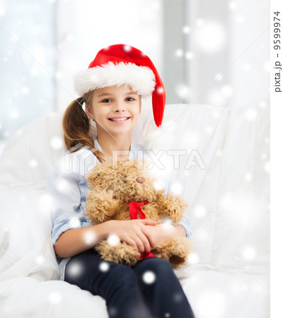 smiling girl in santa helper hat with teddy bear smiling girl in santa helper hat with teddy bear 9599974
