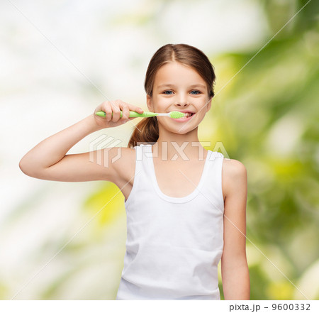 girl in blank white shirt brushing her teeth 9600332