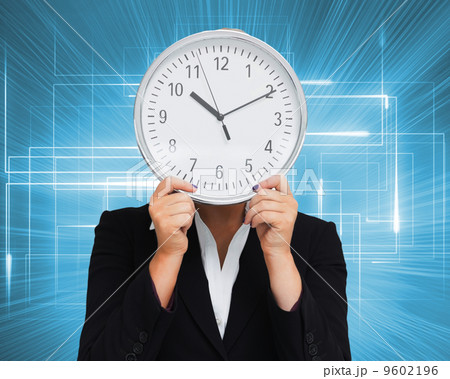 Composite image of businesswoman in suit holding a clock Composite image of businesswoman in suit holding a clock 9602196