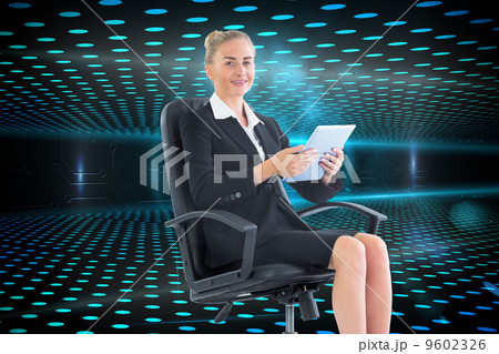 Composite image of businesswoman sitting on swivel chair with ta Composite image of businesswoman sitting on swivel chair with ta 9602326