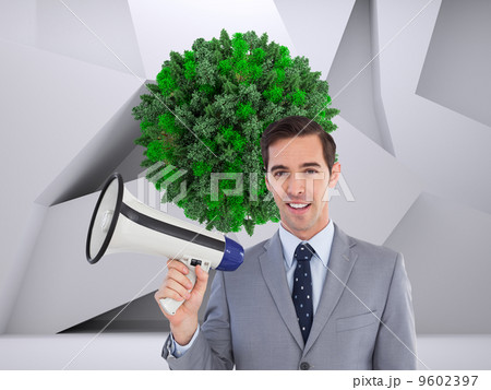 Composite image of smiling businessman holding a megaphone 9602397