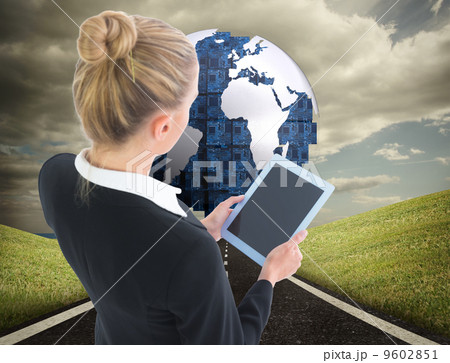 Composite image of businesswoman holding tablet Composite image of businesswoman holding tablet 9602851