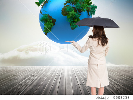Composite image of elegant businesswoman holding black umbrella 9603253