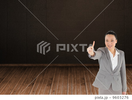 Composite image of smiling asian businesswoman pointing Composite image of smiling asian businesswoman pointing 9603276