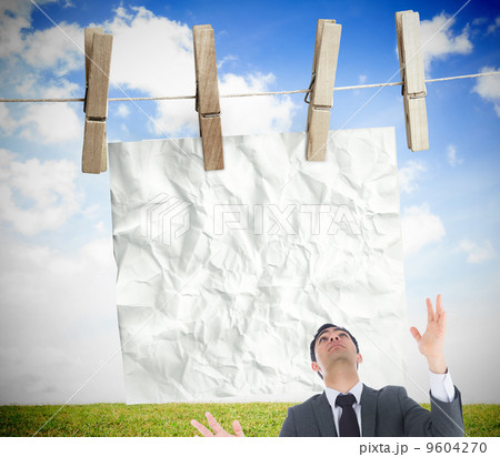 Composite image of unsmiling businessman catching 9604270