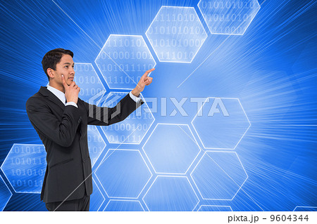 Composite image of thoughtful asian businessman pointing Composite image of thoughtful asian businessman pointing 9604344