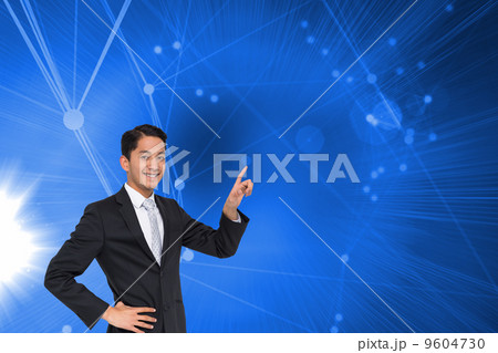 Composite image of smiling asian businessman pointing Composite image of smiling asian businessman pointing 9604730