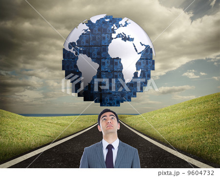 Composite image of unsmiling businessman standing Composite image of unsmiling businessman standing 9604732
