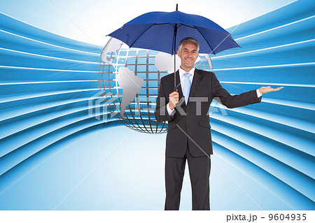 Composite image of peaceful businessman holding blue umbrella 9604935