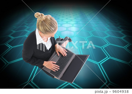 Composite image of businesswoman using laptop 9604938