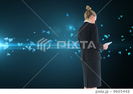 Composite image of businesswoman holding new tablet 9605448