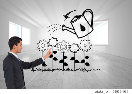 Composite image of serious asian businessman pointing 9605465