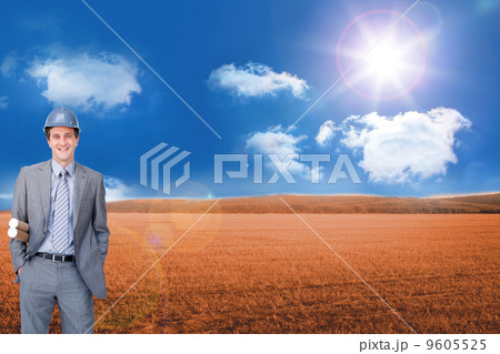 Composite image of smiling attractive architect on phone holding Composite image of smiling attractive architect on phone holding 9605525