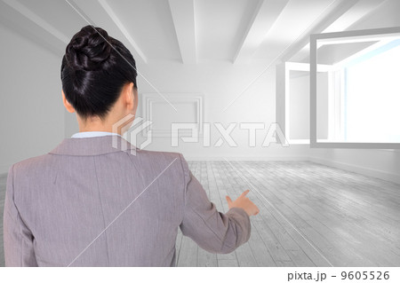 Composite image of asian businesswoman pointing 9605526