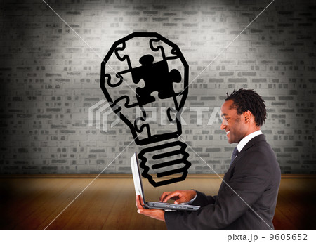 Composite image of businessman working on laptop Composite image of businessman working on laptop 9605652