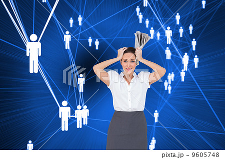 Composite image of worried stylish businesswoman holding newspap 9605748