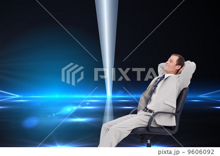 Composite image of side view of businessman leaning back in his Composite image of side view of businessman leaning back in his 9606092