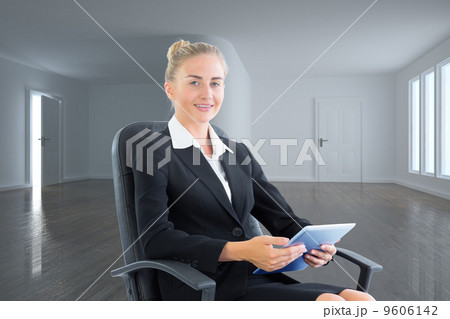 Composite image of businesswoman sitting on swivel chair with ta Composite image of businesswoman sitting on swivel chair with ta 9606142