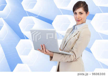 Composite image of confident young businesswoman with laptop 9606300