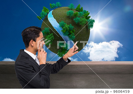 Composite image of thoughtful asian businessman pointing 9606459
