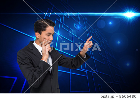 Composite image of thoughtful asian businessman pointing Composite image of thoughtful asian businessman pointing 9606480