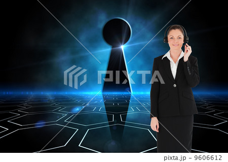 Composite image of good looking woman in suit using headphones a 9606612